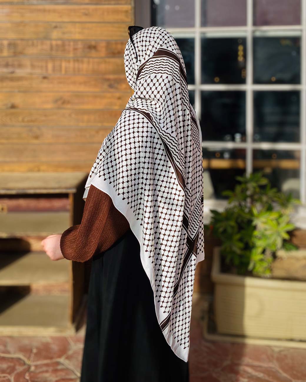 Modest styling of the Palestine headwrap, demonstrating its unique white and brown color palette in premium chiffon.