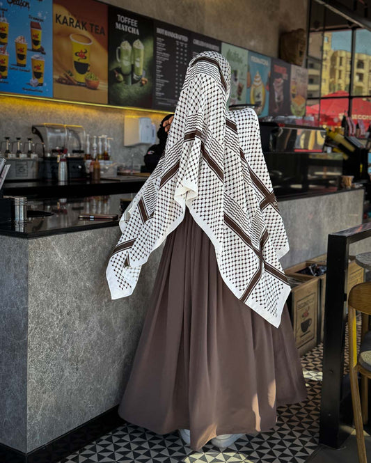 Detailed back view displaying the symmetric distribution of the brown heritage pattern on white luxury chiffon hijab.