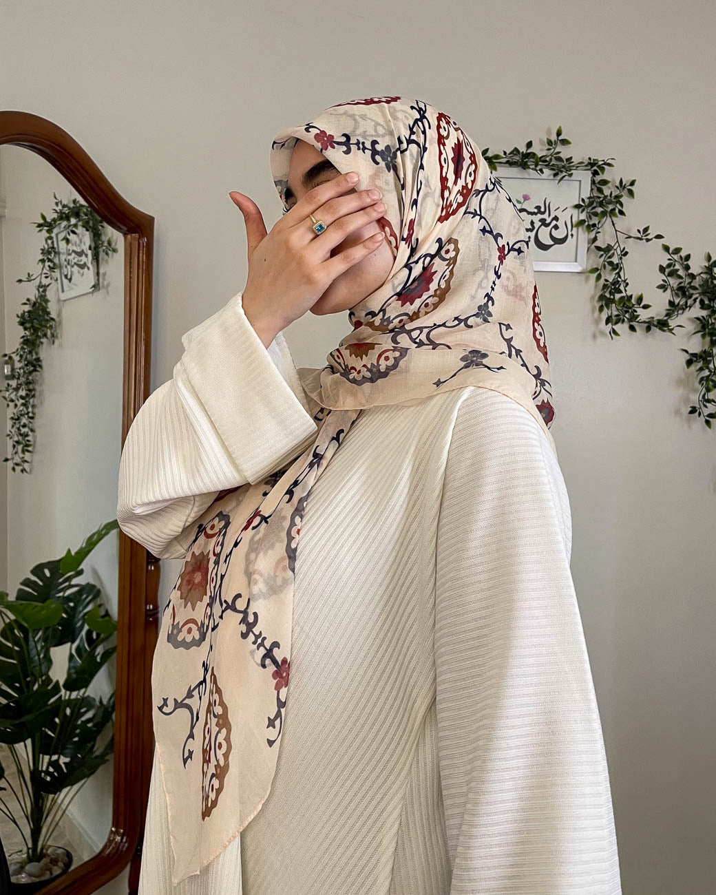 Close-up shot emphasizing the premium quality gauze fabric texture and the depth of the detailed burgundy architectural motifs on the Hadiyah scarf.