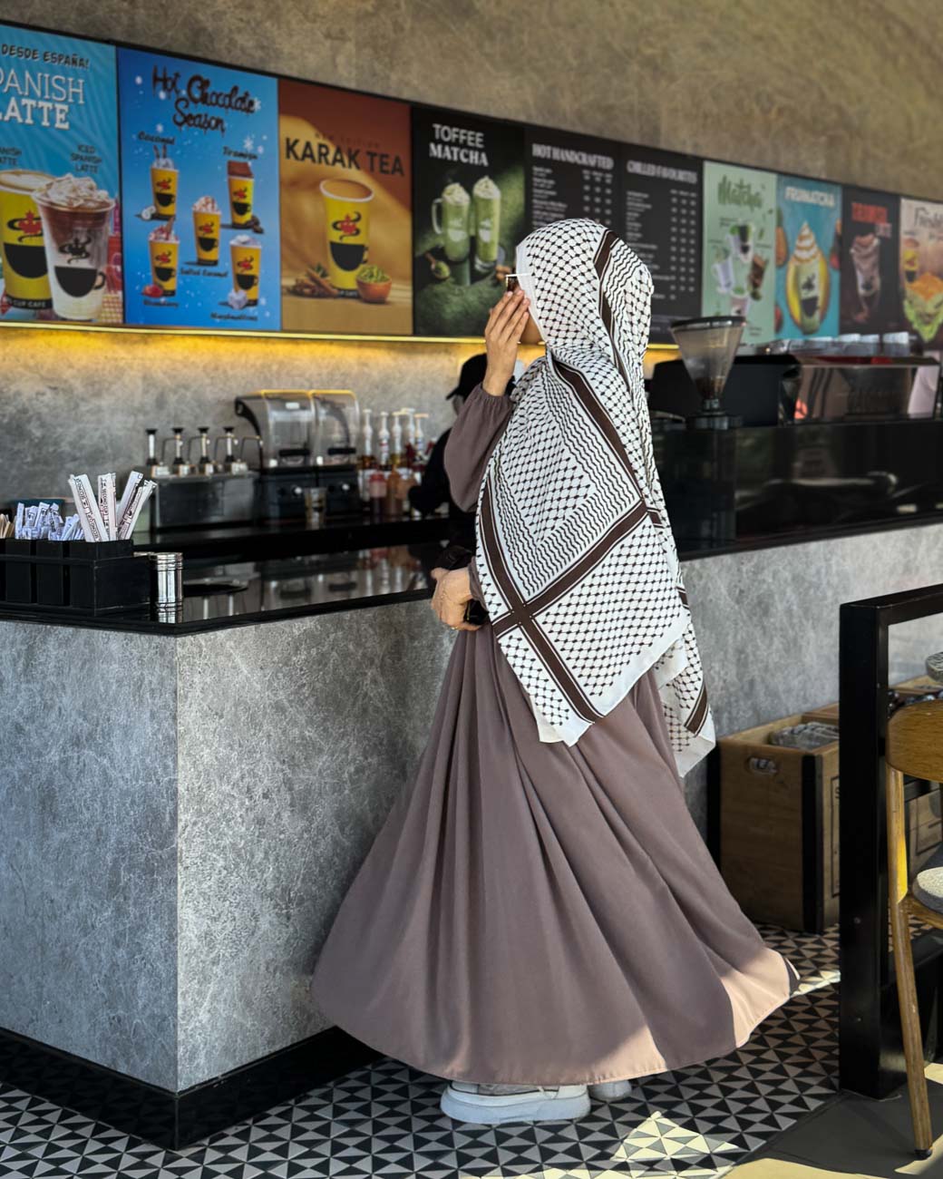 Side profile showcasing the elegant, silky drape of the white and brown Palestine chiffon scarf.