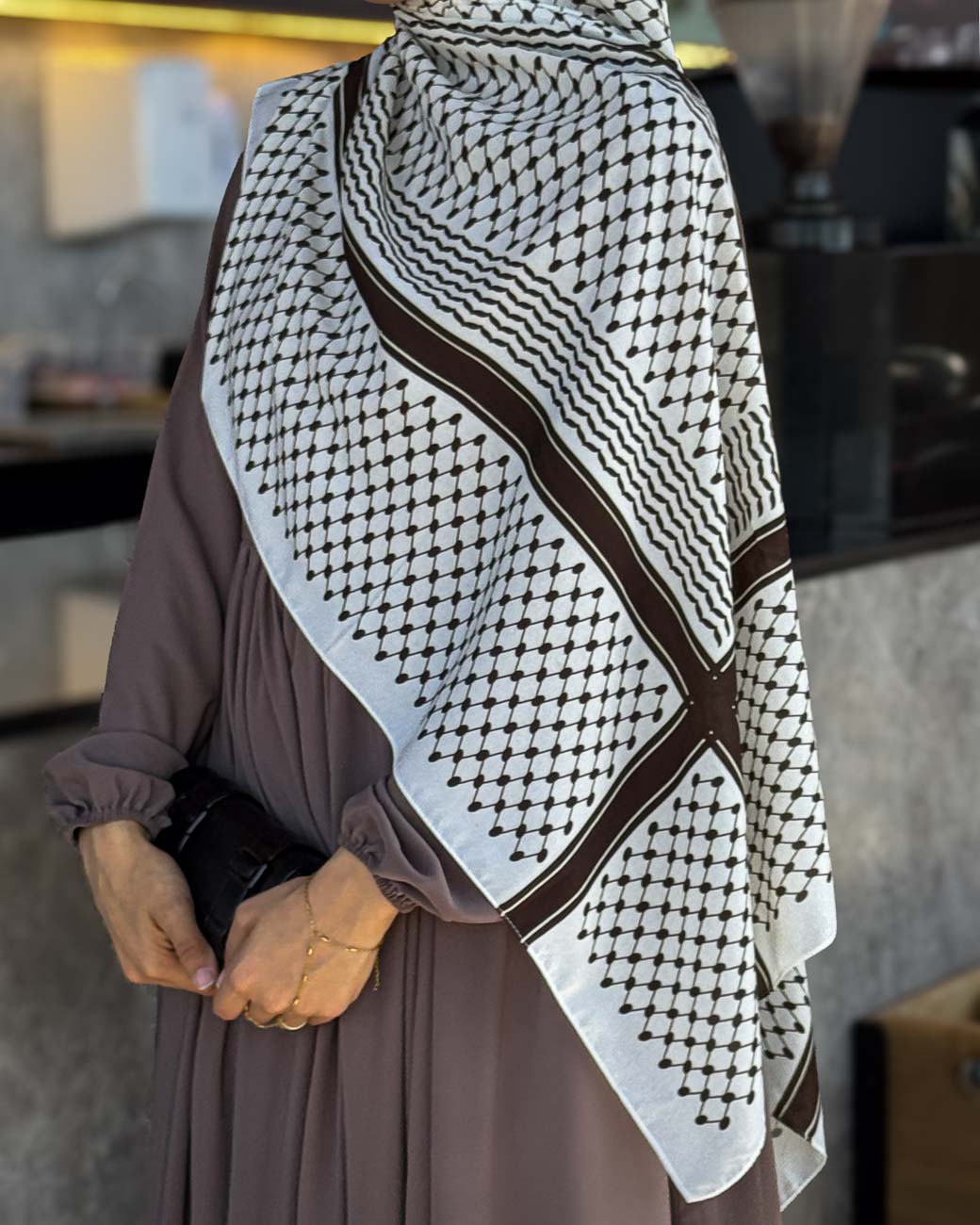 Close-up shot emphasizing the premium quality chiffon fabric texture and the depth of the burnt brown cultural symbols.